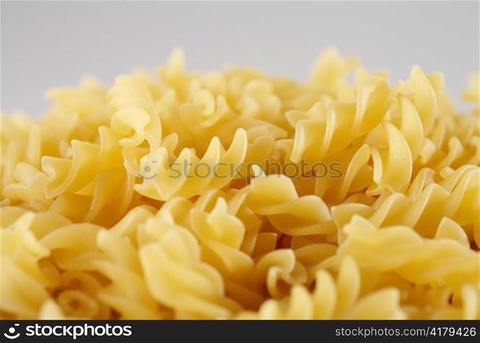 Uncooked pasta Fusilli, short depth-of-field.