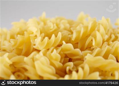 Uncooked pasta Fusilli, short depth-of-field.