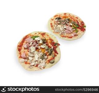 Uncooked pizzas on white