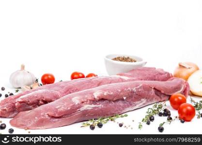 uncooked raw meat fillet with serving spices on white background