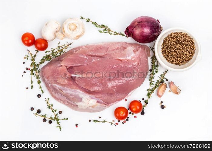 uncooked raw turkey fillet with serving spices on white background