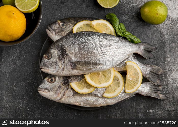 uncooked seafood fish with slices lemon