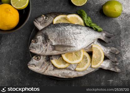 uncooked seafood fish with slices lemon
