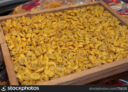Uncooked Tortellini Italian Pasta in Wooden Compartmented Box
