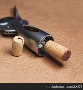 Uncork a bottle of wine, on brown background.