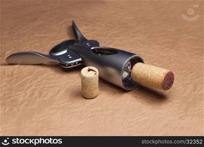 Uncork a bottle of wine, on brown background.