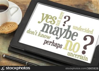 undecided or uncertain concept - yes, no, maybe word cloud on a digital tablet with a cup of coffee