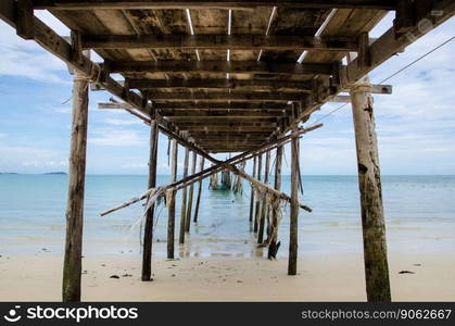 under of old bridge on beach