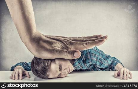 Under pressure of boss. Tired young woman pressed with hand to table