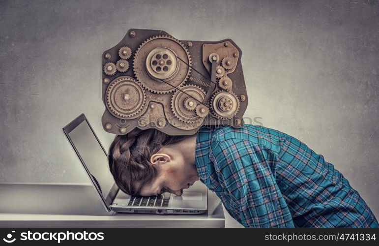 Under pressure of work. Woman programmer pressed with engine mechanism to laptop