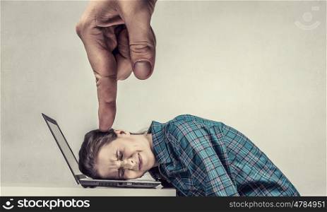 Under pressure of work. Woman programmer pressed with finger to laptop