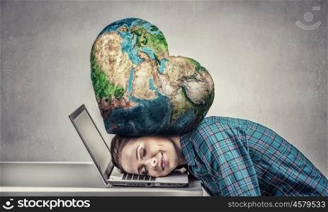 Under pressure of work. Woman programmer pressed with globe to laptop. Elements of this image are furnished by NASA