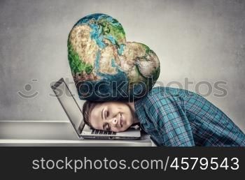 Under pressure of work. Woman programmer pressed with globe to laptop. Elements of this image are furnished by NASA