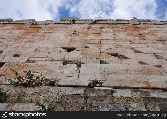 Under the Acropolis wall. Plants and flowers growing on ancient ruins, Athens Greece.