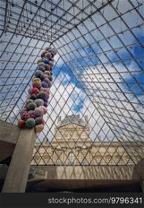 Underneath the Louvre glass pyramid, vertical background. Beautiful architecture details with an abstract mixture of classical and modern styles