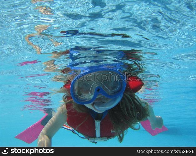 Underwater view of a young girl (12-13) scuba diving, Moorea, Tahiti, French Polynesia, South Pacific