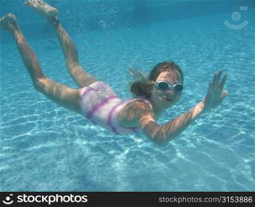 Underwater view of a young girl swimming, Moorea, Tahiti, French Polynesia, South Pacific