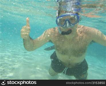 Underwater view of a young man scuba diving, Moorea, Tahiti, French Polynesia, South Pacific