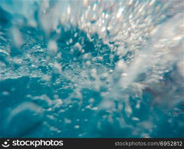 Underwater view of bubbles in motion.