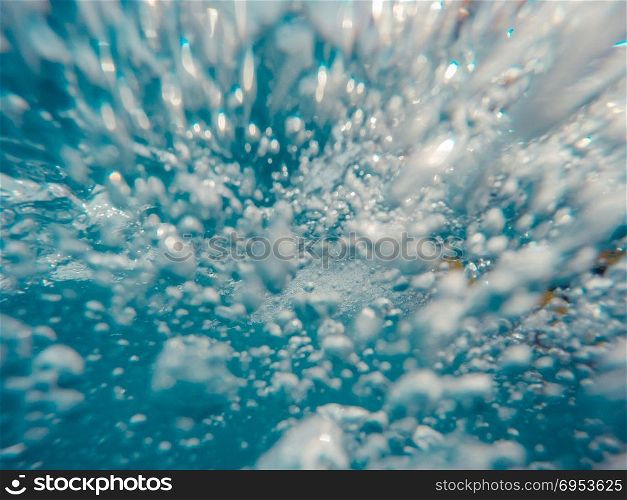Underwater view of bubbles in motion.