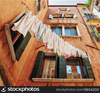 Underwear drying on the rope in the old yard in Italy