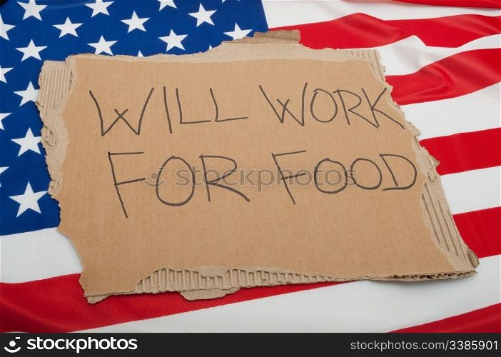 Unemployment in USA - Sign Will Work For Food on Cardboard on American Flag