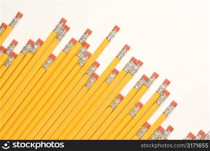 Uneven diagonal row of eraser ends of pencils.