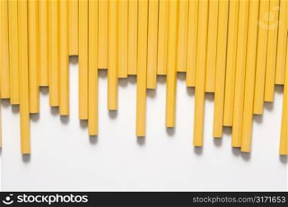 Uneven row of unsharpened pencils.