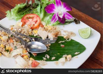 Unfinish eating fried rice with salted egg and shrimp on wooden table