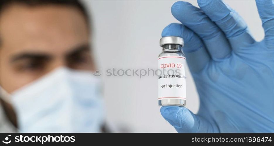 unfocused doctor looking vaccine recipient