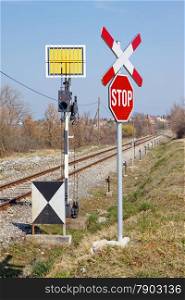 unguarded railway crossing with railways signs