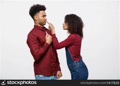 Unhappy African American couple in casual clothes arguing and figthing. Unhappy African American couple in casual clothes arguing and figthing.