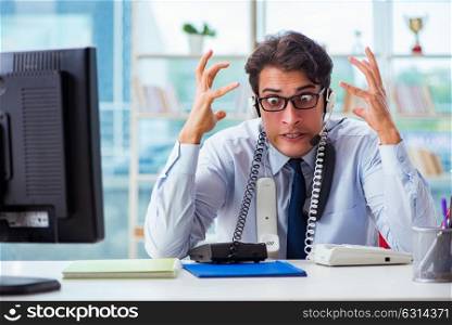 Unhappy angry call center worker frustrated with workload. The unhappy angry call center worker frustrated with workload