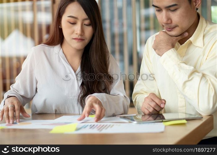 Unhappy Asian couples are calculating income And expenses To cut unnecessary expenses. Concepts for investment planning and financial planning for the family, Problems with money in the family