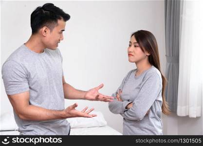 Unhappy Asian Couples standing beside each other and women avoid talking or quarrel, Cause of angry, quarrel, relationship problems and having misunderstanding or disagreement. Family problems concept