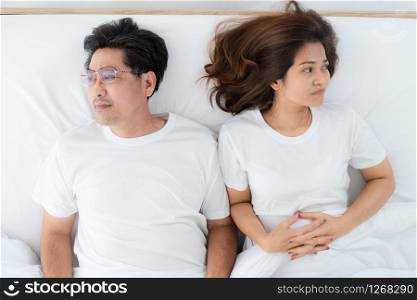 Unhappy Asian senior couple in bedroom. Retirement and bad relationship elderly concept.