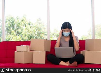 Unhappy Asian young entrepreneur on a mask, Tired expression And fed up with problems in doing business at home office, Concept of merchant business online and eCommerce