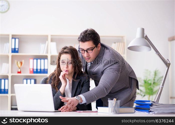 Unhappy boss having a chat with his secretary