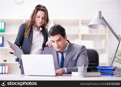 Unhappy boss having a chat with his secretary