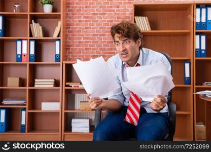 Unhappy businessman sitting in the office 