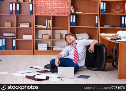 Unhappy businessman sitting in the office . The unhappy businessman sitting in the office 