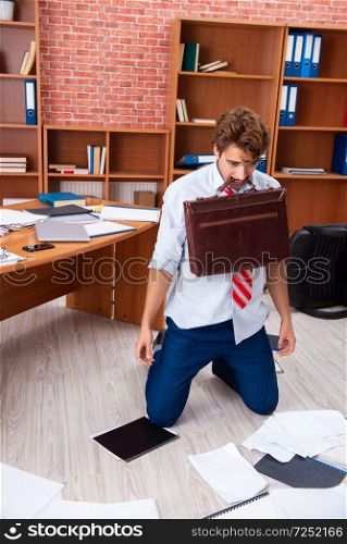 Unhappy businessman sitting in the office . The unhappy businessman sitting in the office 