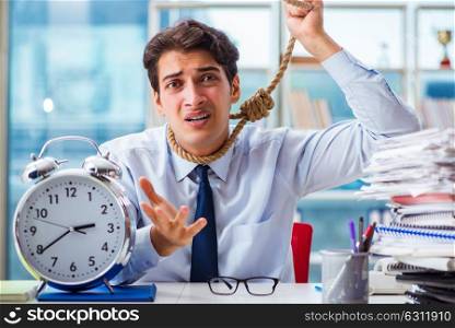 Unhappy businessman thinking of hanging himself in the office. The unhappy businessman thinking of hanging himself in the office