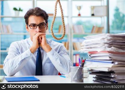 Unhappy businessman thinking of hanging himself in the office. The unhappy businessman thinking of hanging himself in the office