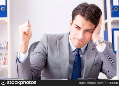 Unhappy businessman working in office