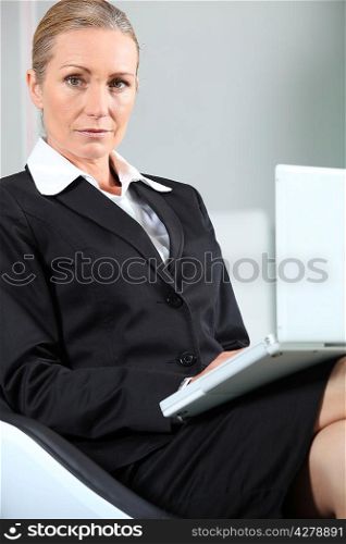 Unhappy businesswoman with laptop.