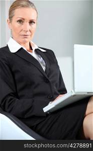 Unhappy businesswoman with laptop.