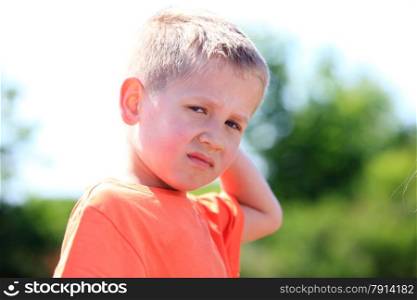 unhappy child expression. Sad little boy outdoor