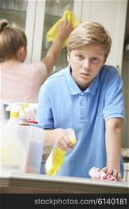 Unhappy Children Helping to Clean House