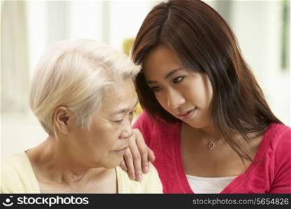 Unhappy Chinese Mother Being Comforted By Adult Daughter